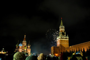 Fototapeta na wymiar salute in honor of the new year 2020 on red square against the Kremlin, Spasskaya tower and St. Basil's Cathedral
