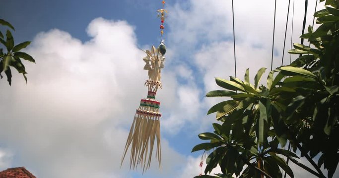 Religious amulet on a pole. Bali temple Indonesia. Traditional indonesian hindu symbol. Ancient religious spiritual symbol decoration waving on wind. Balinese Asian culture. Tourism and travel concept