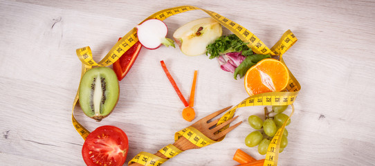 Cantimeter and clock made of fruits and vegetables containing minerals, time to diet and slimming concept