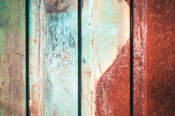 Rusty metal fence of corrugated flooring. Rear background.