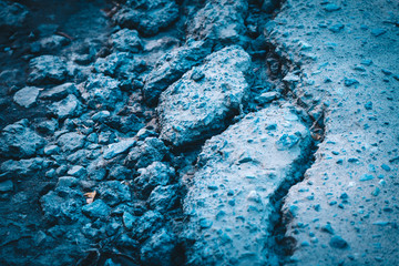 The crack of collapsed asphalt from improper laying workers road.