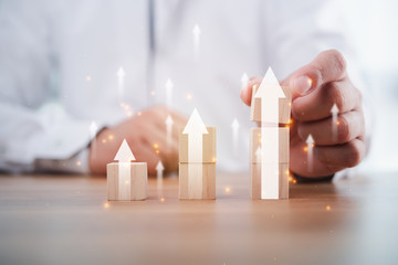 Business development to success and growing growth concept.businessman try to arrange wooden blocks...