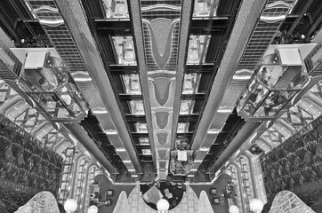 Birdseye view into futuristic interior design in main lobby or atrium with panoramic elevators and...