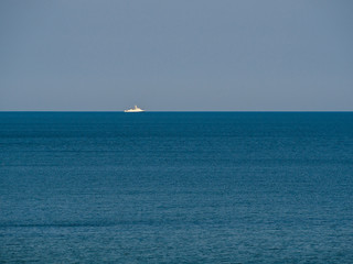 Warship of coast guard on the horizon, patrolling in a calm sea. Baltic sea