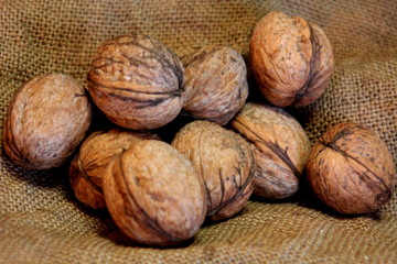 A walnut lies on an old cloth.