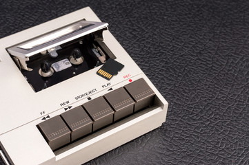 Obraz premium audio cassette player with memory card on a black background. 