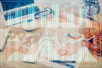 Double exposure of chart and financial info and work space with computer background. Concept of...