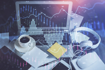 Financial graph colorful drawing and table with computer on background. Multi exposure. Concept of...