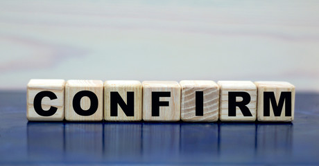 concept word confirmation on wooden cubes on a beautiful background