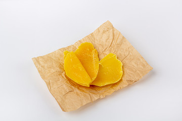 Dried Mango slices. Organic homemade dry fruit chips in a paper eco pack on a white background. Healthy vegan snack. The concept of proper nutrition, organic and vegetarian food, copy space.