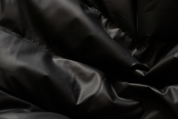 background of a black puffer jacket close up