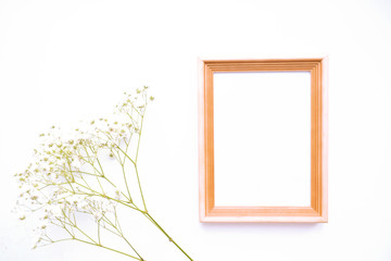 Frame for text with white flowers on a white table.  Top view, copy space.