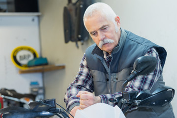 senior man wants to travel by motorbike
