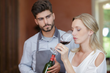 a woman is trying wine