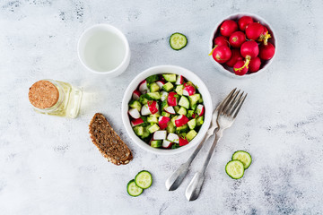 Radish cucumber salad with greens in bowl