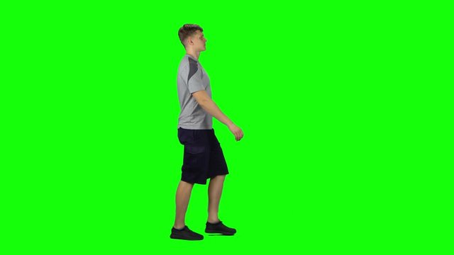 Young man goes then starts to run, Chroma Key. Profile side view