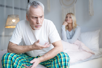 Adult man gesturing and frowning stock photo