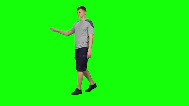 Male goes and dances, smiles and rejoices on a green screen, Chroma Key
