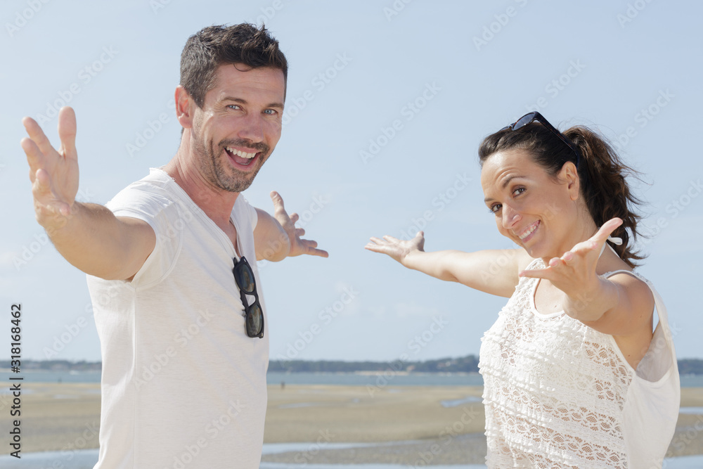 Wall mural a happy couple with arms opened