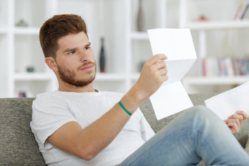 relaxed man sitting reading a document