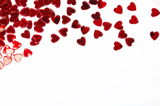 Red heart shaped confetti isolated on white background