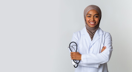 Portraif Of Black Islamic Female Doctor In Hijab Posing With Stethoscope