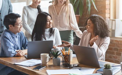 Professional afro woman sharing business ideas with colleagues