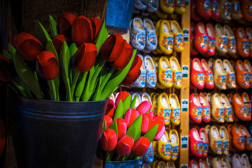 Fototapeta na wymiar Traditional wooden shoes and wooden tulips in souvenir shop, Netherlands