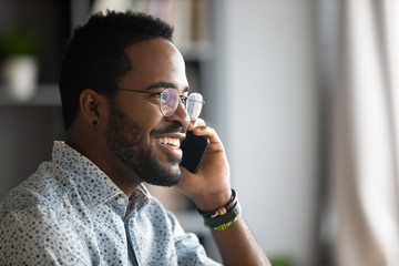 Smiling african business man making business call talking on phone