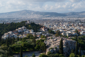 Fototapeta na wymiar Athens, Greece - Dec 20, 2019: View from the Acropolis of the Athens skyline and the Areopagus (Ares Rock), under a hazy sky caused by dust clouds