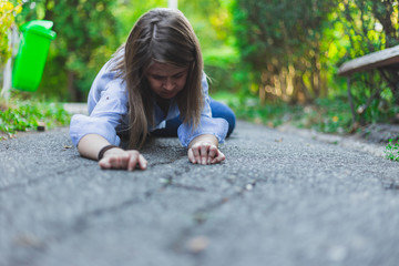 Sick young woman felt on the ground