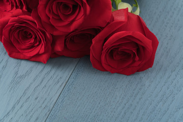 Red roses on blue wood table