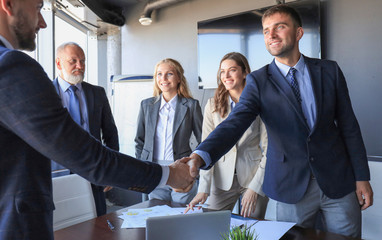 Business people shaking hands, finishing up a meeting.
