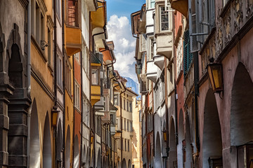 Fototapeta na wymiar The famous road Via dei Portici with arcades on both sides in Bolzano, South Tyrol, Italy