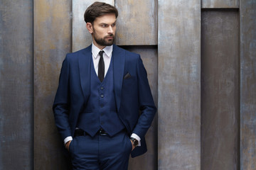 indoor photo of young handsome stylish businessman wearing suit