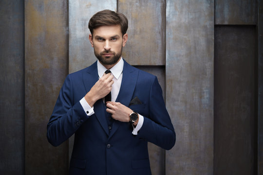 indoor photo of young handsome stylish businessman wearing suit