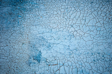 Old peeling paint on concrete wall of a house