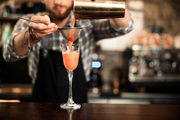 Barman is experimenting with creating cocktail drinks