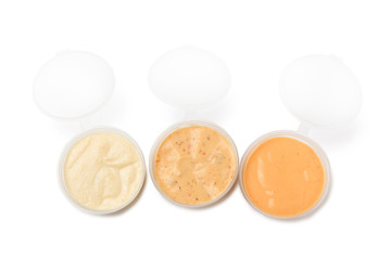 Three dip sauces in a plastic take away container