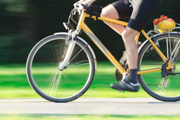 Obraz na płótnie Canvas Riding bicycle - blurred motion, fast driving.