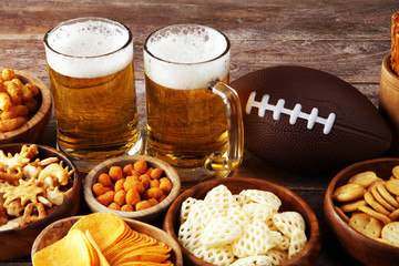 Chips, salty snacks, football and Beer on a table. Great for Bowl Game snack projects.