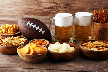 Chips, salty snacks, football and Beer on a table. Great for Bowl Game snack projects.