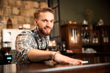 Happy young man working in cafe