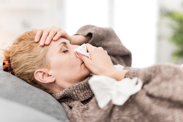 Fototapeta na wymiar Woman sick in the bed, flu and virus infections, allergy, seasonal health issues.