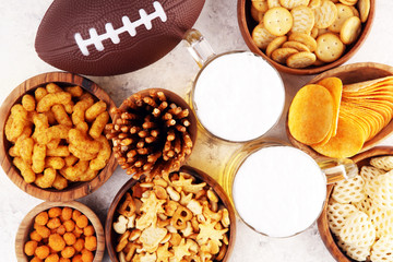 Chips, salty snacks, football and Beer on a table. Great for Bowl Game snack projects.