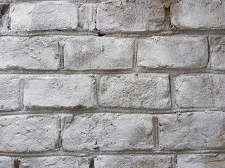 Old red brick wall with damaged white paint layer, closeup background photo texture. Seamless composition