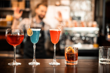 Beautiful row line of different colored alcohol cocktails