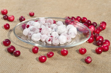 Cranberries in sugar and scattered fresh berries on burlap