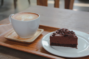 Chocolate cake with latte art coffee. 