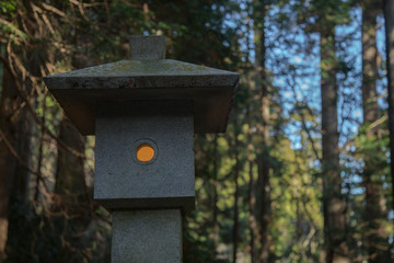 Traditional Japanese lantern with light in the forest